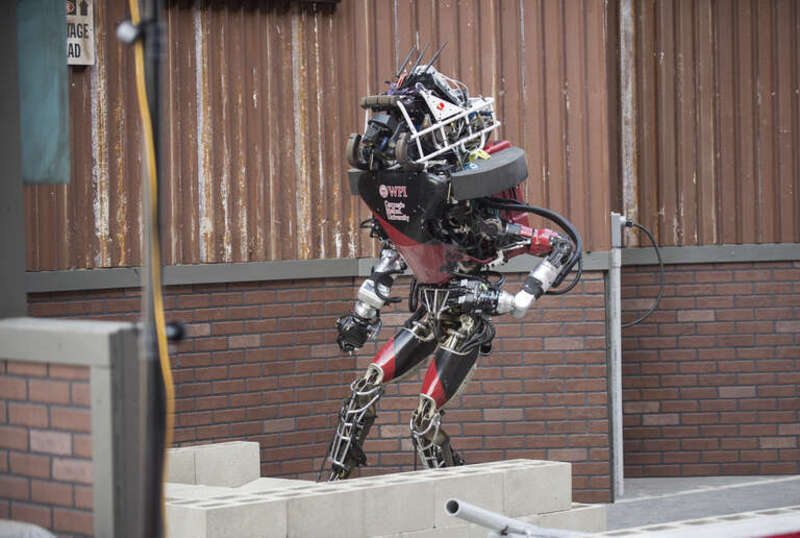 WARNER, a teaming of Worcester Polytechnic Institute and Carnegie Mellon University, navigates over an obstacle during the Defense Advanced Research Projects Agency (DARPA) Robotics Challenge (DRC) June 5 in Pomona, California. The DRC is a