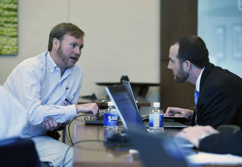 Sam Septembre, Office of Naval Research (ONR) Global science advisor to Fleet Cyber Command, talks with Steve Roesch, Navy account representative with SAS, during an industry tour of ONR science advisors to North Carolina's Research Triangle. Science