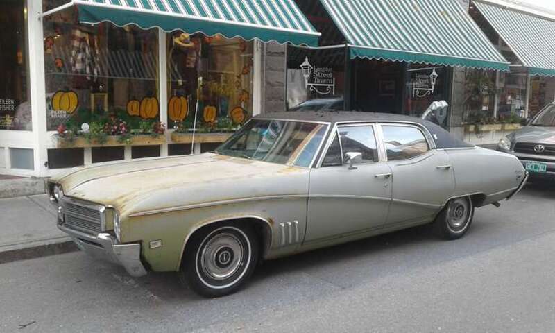 Rusty bronze 1969 Buick Skylark Custom 4-Door Sedan parked on Langdon Street in downtown Montpelier, Vermont.
