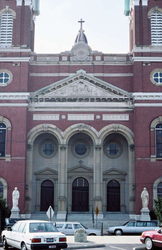 Detail of Mother of God Catholic Church (built 1870-1871 in an Italian Renaissance basilica style).
Statues on either sided of steps represent Saints Peter and Paul.
Above the portico are the words &quot;Mutter Gottes Kirche&quot;, German for Mother of God