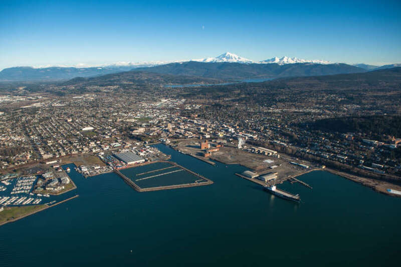 Aerial View of Bellingham, Washington including the waterfront redevelopment, downtown, and Mount Baker in the distance.