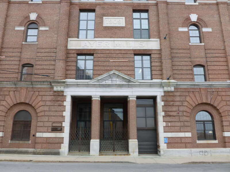 The east entrance of one of the Ayer Mills, located on the corner of Merrimack Street and the west side of South Union Street, in Lawrence, Massachusetts.  Stone molding above the entrance reads &quot;1909&quot;.