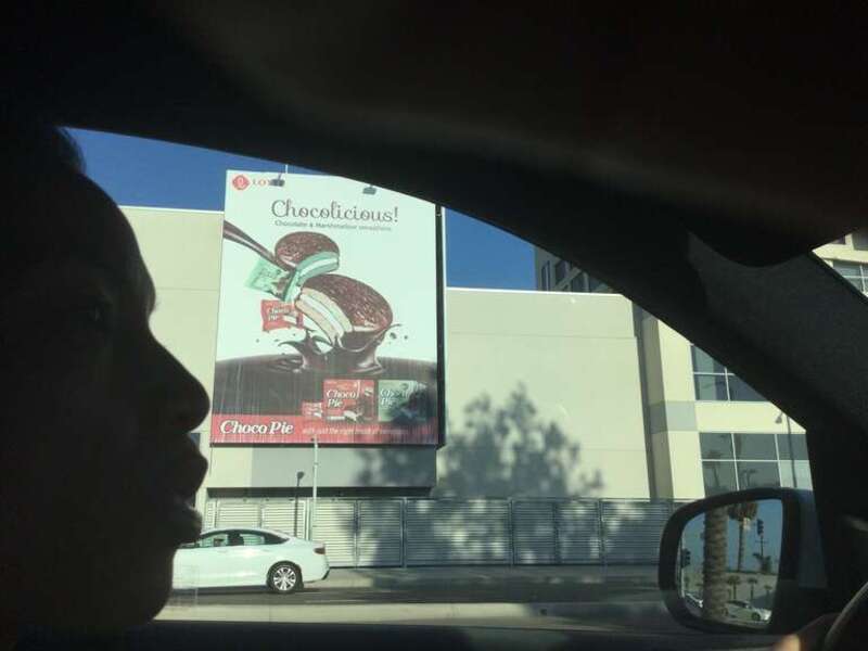 A poster by Lotte Choco Pie displaying the word “Chocolicious!” in Buena Park on CA-39 south at Orangethorpe Ave. Located in “The Source”.