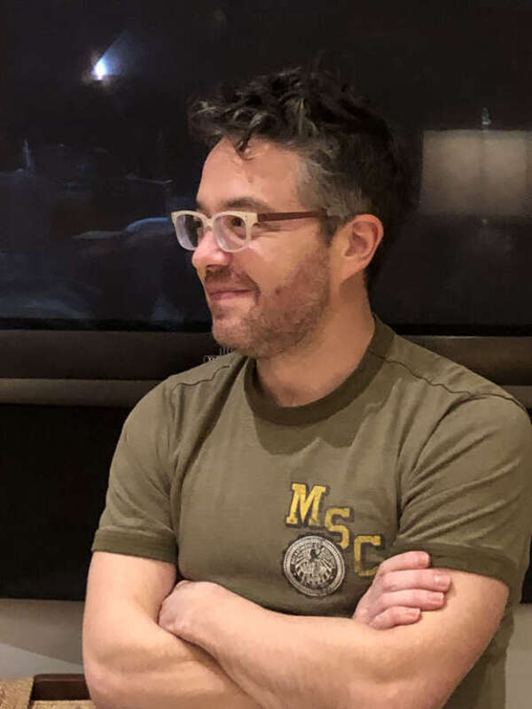 This photograph depicts a candid picture of American composer Sean Shepherd (born 1979).  The photograph was taken inside Shepherd's home on 13 January 2022