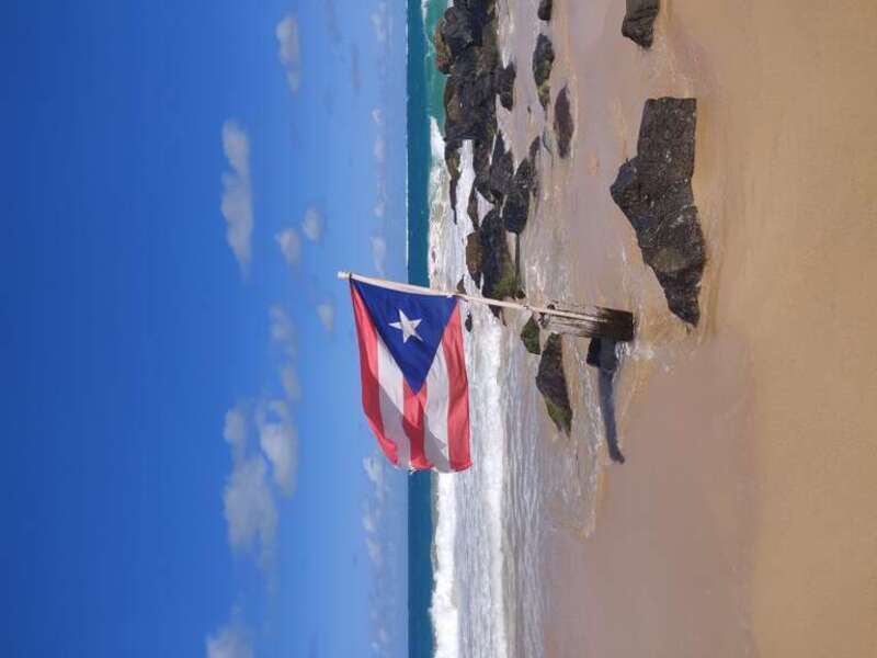 Puerto Rican flag waves at Condado beach in San Juan, Puerto Rico