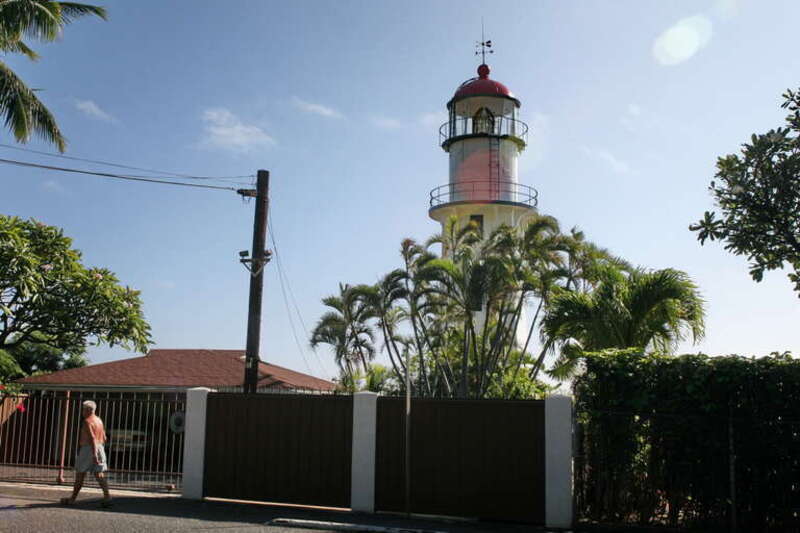 The commercially-powered light is backed up by a battery-powered light equipped to switch on in case of power outage. An electronic sensing device also monitors the main light and activates the backup light in case of any type of failure. The clocks