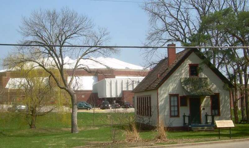 The historic one-room Eyestone School with Redbird Arena in the background on the campus of Illinois State University, Normal, Illinois. Originally the Rose Hill School, this building was moved to this location in 1965 and rededicated to the memory