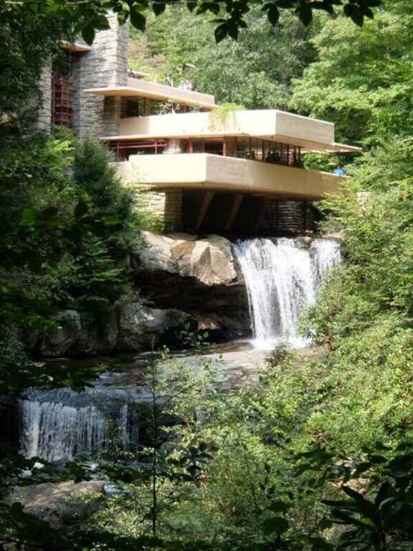 A photograph of the Frank Lloyd Wright designed house Falling Water from downstream and across the river.