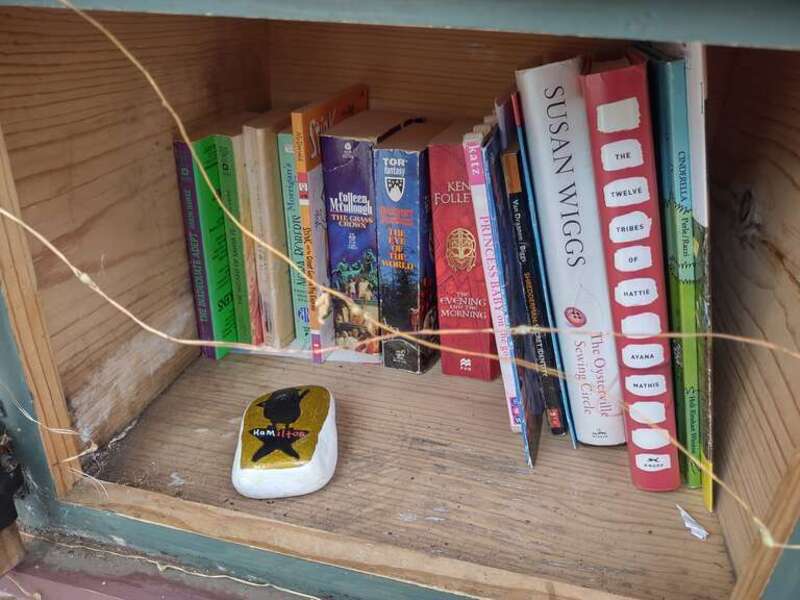 The front of a Hamilton themed painted stone, featuring a minion.