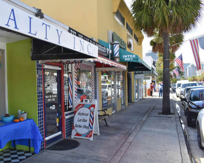A marquee identifies the Las Olas Barbershop, since 1951.