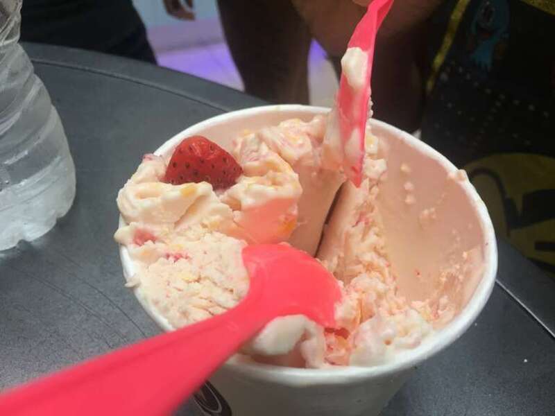 Ice cream cup with a couple of spoons on it