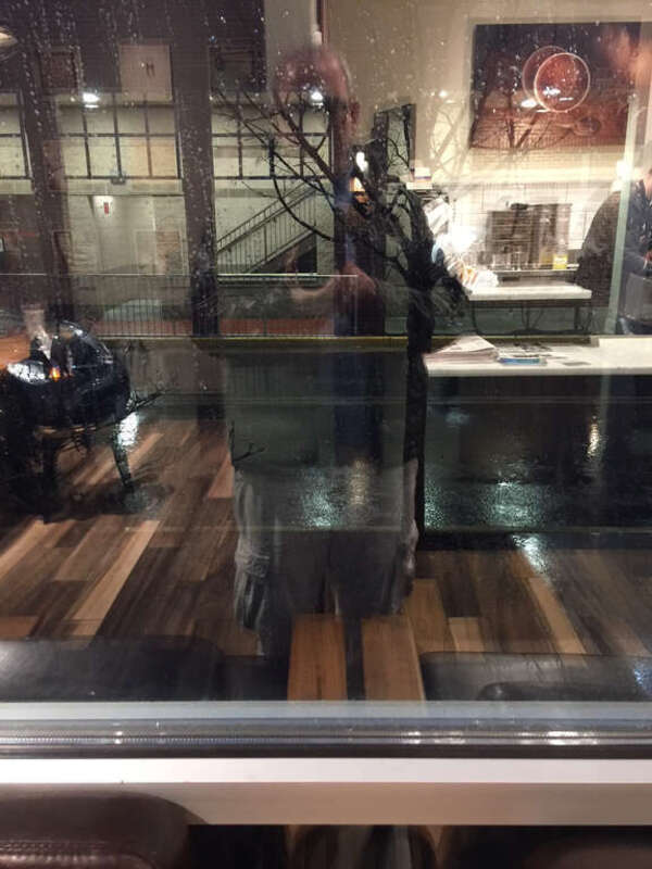 500px provided description: Looking through the window of a warm coffee shop onto the cold rainy street outside [#cold ,#rain ,#cafe ,#warm ,#apartment ,#table ,#coffee shop ,#lobby ,#convenience ,#sidewalk cafe ,#Street]