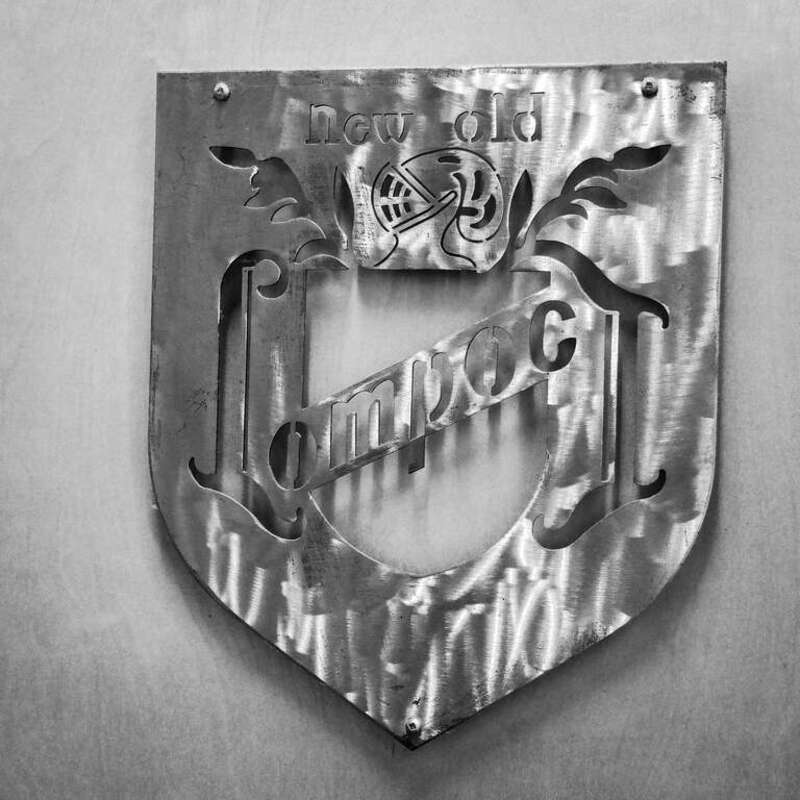 A metal art logo at Lompoc Fifth Quadrant in Portland, Oregon