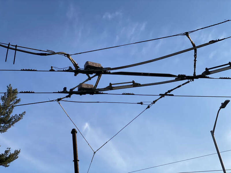 Trolley switch. Photo of MBTA overhead wires that supply electric power for the trackless trolley (trolleybus) system that radiated from Harvard Square station in Cambridge, Massachusetts (Routes 71, 72 and 73). Trackless trolley service on these
