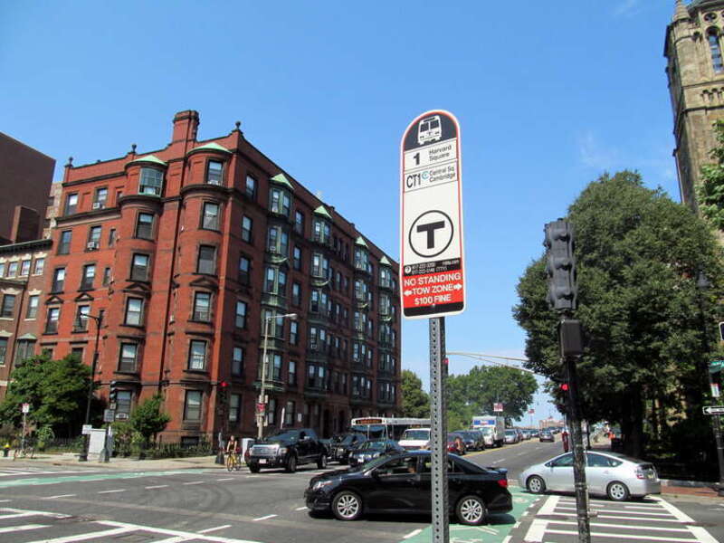 A bus stop sign for the #1 and CT1 routes, located at the corner of Massachusetts Avenue and Beacon Street