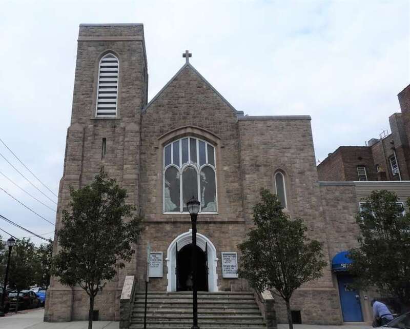 Looking west at stone church on a cloudy day.