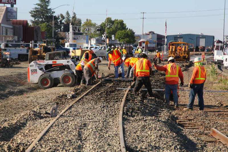 Workers complete final grading of the approach to a new railroad bridge in Napa, Calif., before its official opening in a ceremony June 22, 2011. The U.S. Army Corps of Engineers Sacramento District built the bridge to replace a lower adjacent