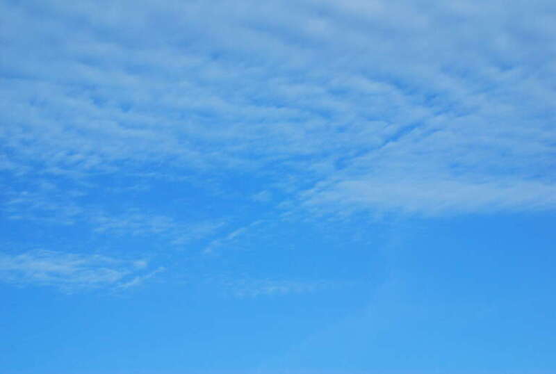 We saw this kind of path while flying into Laguardia too. Its clearly created by an airplane flying level or passing through the altitude where the cloud forms. The mixing caused by the passage pushes the moist air down to a warmer altitude or