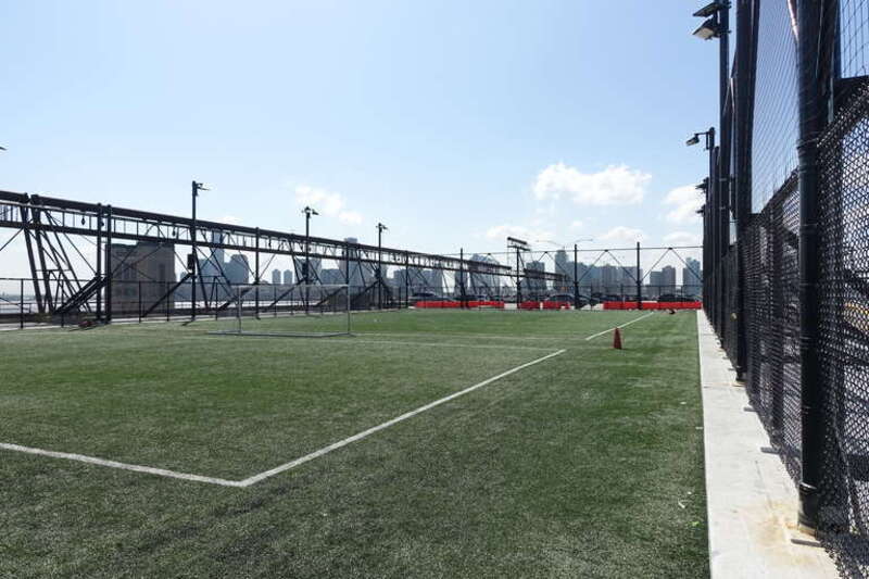 Inside the second rooftop athletic field at the southeast corner of the third floor deck of Pier 40, at the west end of Houston Street at West Street in Hudson Square, Lower Manhattan.