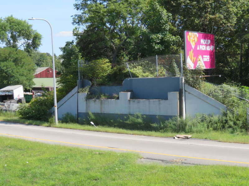 A bridge abutment that formerly carried the Providence and Springfield Railroad next to an entrance ramp for US 6, seen in September 2018. The bridge was removed in 2013 when the exit was reconfigured.