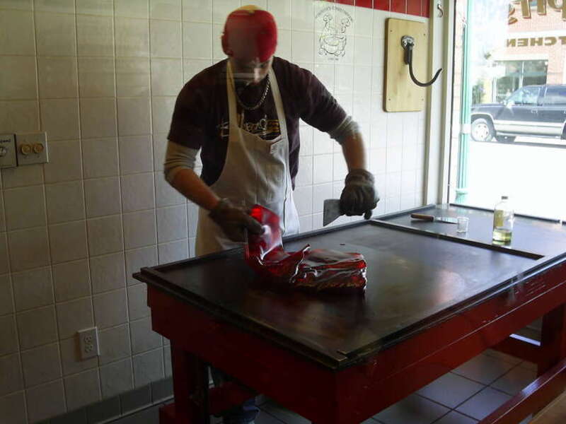 Man making red hot candy drops at Schimpff's Confectionary.