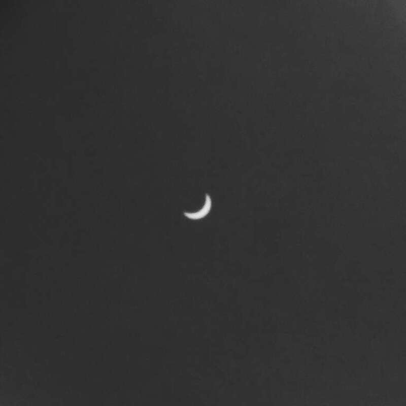 The 2017 solar eclipse as seen from Denver, near the eclipse maxima. This is actually a picture of an image of the Sun (and the Moon, really, but you can't see that) projected on a paper plate using a pinhole setup devised by John Michael Watkins.