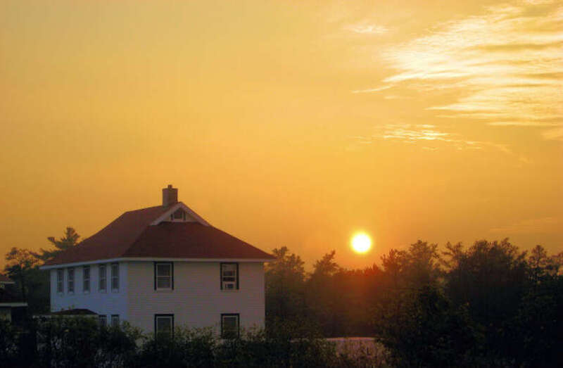 Sunset in Michigan. Looking towards the old Coast Guard station [1][2][3] near Whitefish Point Light, Whitefish Bay, Chippewa County, Michigan, United States. Photo also on Flickr. [4]