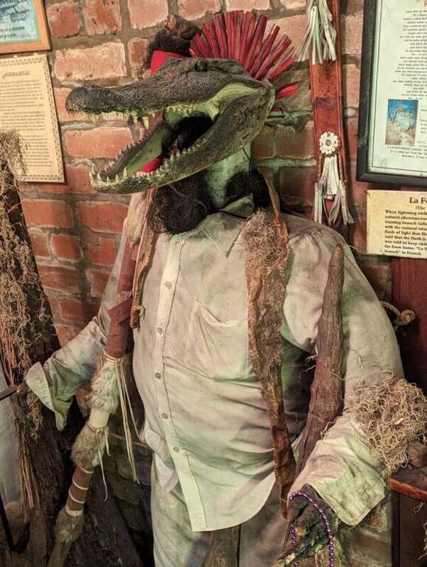 New Orleans Voodoo Museum.   
This was not explicitly identified as a zombie, but was near a discussion of the zombie phenomenon. I inferred that the zombie was given an alligator head because it would be disrespectful to depict an actual zombie, as