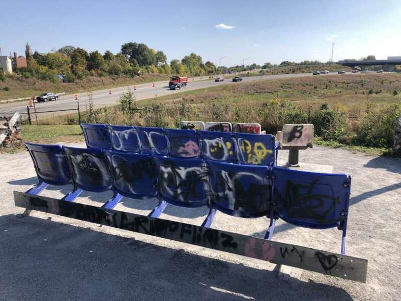 This image depicts outdoor seating overlooking the South Split Interchange (Interstates 65 and 70) at The Idle in Indianapolis, Indiana, U.S. The public park opened in 2018.