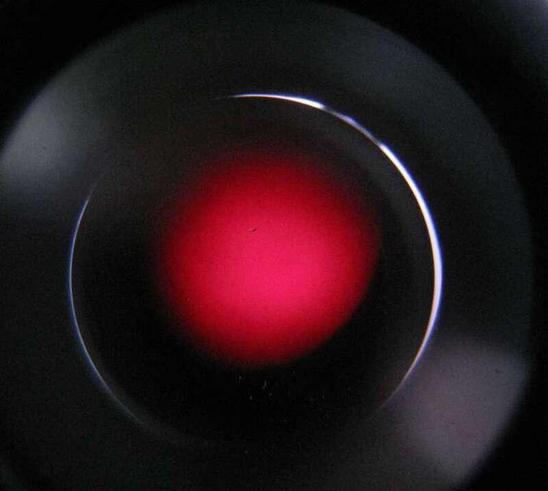 Viewed through H-alpha (Hα) filter telescope.  H-alpha is a specific red visible spectral line created by hydrogen with a wavelength of 656.28 nm, which occurs when a hydrogen electron falls from its third to second lowest energy