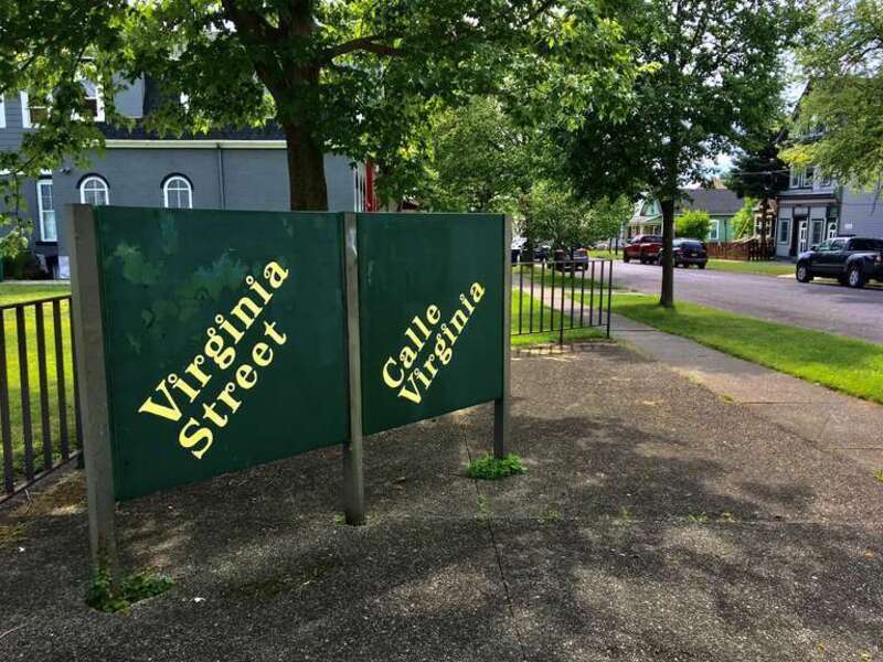A decorative bilingual sign marks the corner of Virginia and Edward Streets on the Lower West Side of Buffalo, New York, as seen in July 2020.