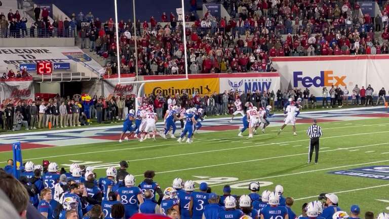 Arkansas quarterback KJ Jefferson (uniform No. 1, white) passes to Jaedon Wilson to score a two-point conversion in double overtime of the 2022 Liberty Bowl at Simmons Bank Liberty Stadium in Memphis, Tennessee.
