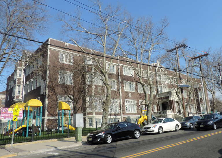 Looking north across Avenue E at YMCA, former school, on a sunny morning.