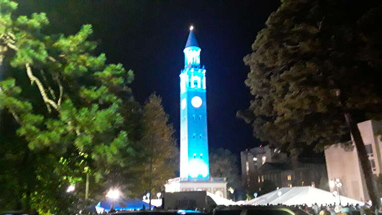 The Bell Tower lit Carolina blue after a w:North Carolina Tar Heels football win in 2019.
