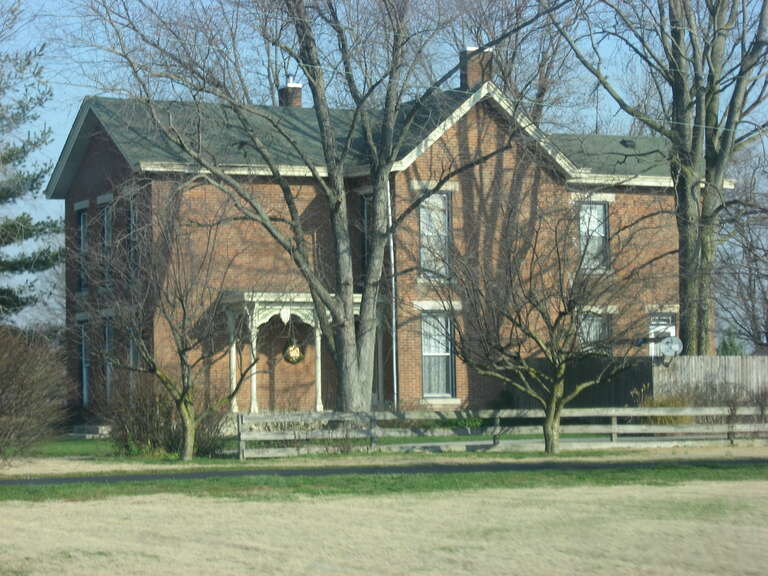 Southern side and front of the David Aikens Farmhouse, located at 2325 Jonesville Road (State Road 11) south of Columbus in Columbus Township, Bartholomew County, Indiana, United States.  Built in 1877, it is listed on the National Register of