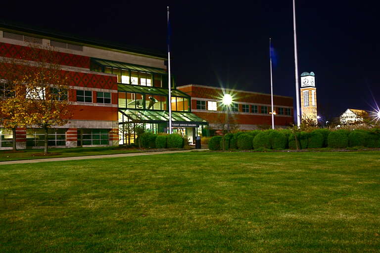 Grand Valley State University Allendale Student Services Building at night.