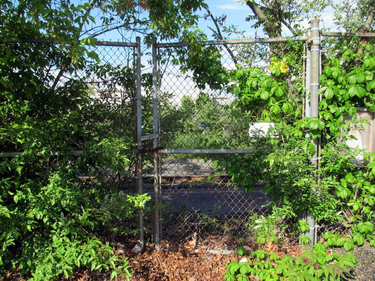 Gate to the former Amtrak platform at Bloom Bus Terminal in June 2017
