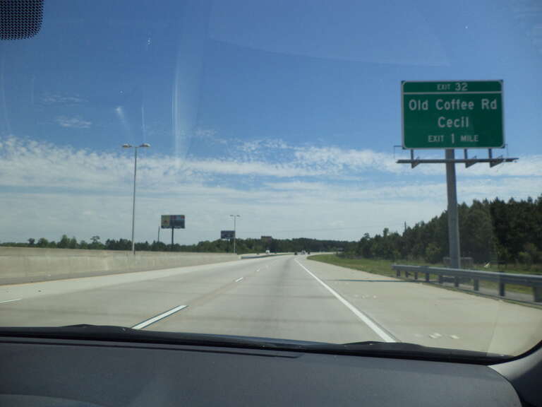 Old Coffee Road/Cecil Exit sign 32 in 1 mile on I75 in rural Cook County, Georgia