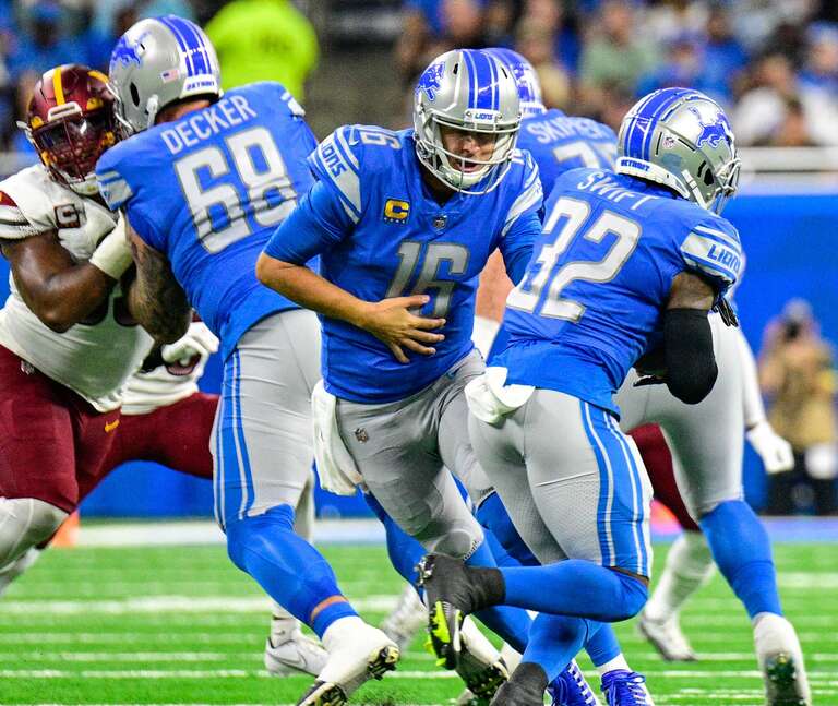 Detroit Lions quarterback, Jared Goff, hands the ball off to running back, D'Andre Swift, in a game against the Washington Commanders at Ford Field, Detroit, MI on September 18, 2022.