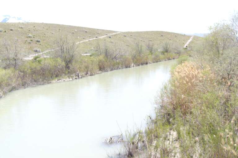 Jordan River in  Midvale.  Trail is on the right (east) side of the River.  Capped tailings from the Sharon Steel  Superfund site is also on the right.