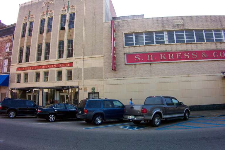 Built in 1934, this three-story Art Deco building has facades on Fifth and Sixth streets. Designed by Edward F. Sibbert, it 
is typical of his work in the early 1930s. The facade is pale brick and terracotta with darker polychrome terracotta