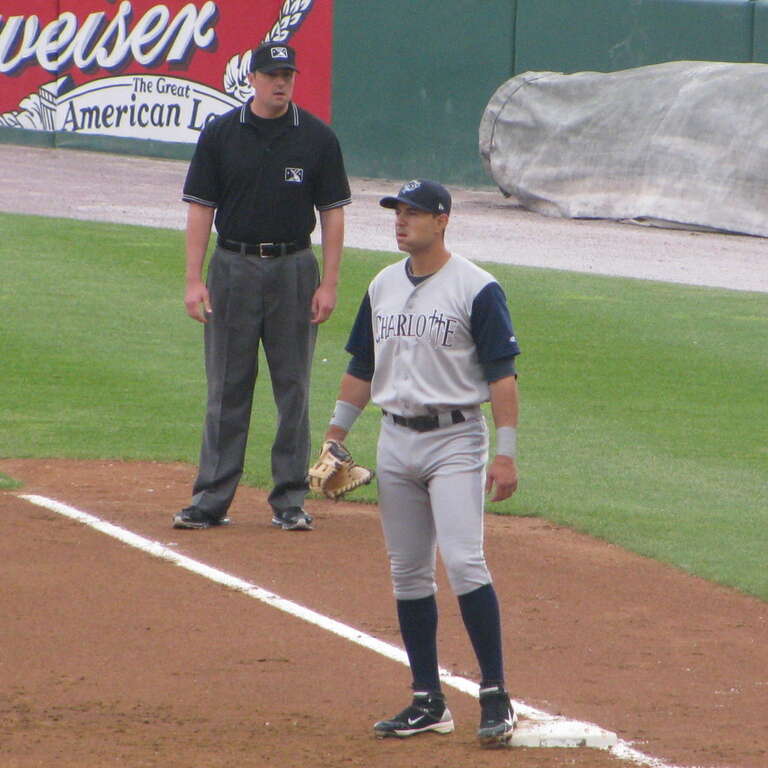 Umpire Lance Barrett, Charlotte Knights first baseman / outfielder, Josh Kroeger.