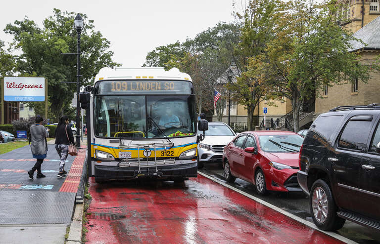 An MBTA route 109 bus on Broadway in Everett in September 2021. At left is a portable structure to test level boarding.