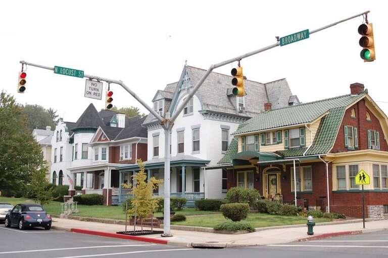 This picture shows a street corner on Broadway near downtown Hagerstown.As typical for rural areas in the United States the lights are rather trivially mounted here on the opposite of the crossroads and extra signals for pedestrian crosswalks are