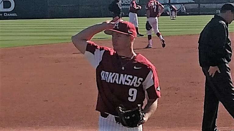 Jax Biggers tosses a baseball to a fan during a baseball game against Dayton in Baum Stadium