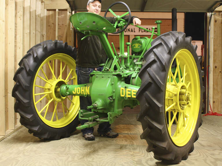 Rear view of a vintage John Deere tractor, swinging drawbar visible below the PTO; West Springfield, Massachusetts, USA