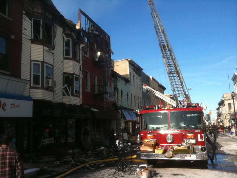 Firefighters from North Hudson Regional Fire and Rescue deal with the aftermath of a fire on Bergenline Avenue between 21st and 22nd Streets in Union City, New Jersey on January 20, 2012. The fire, which started around 9pm on January 18, was not