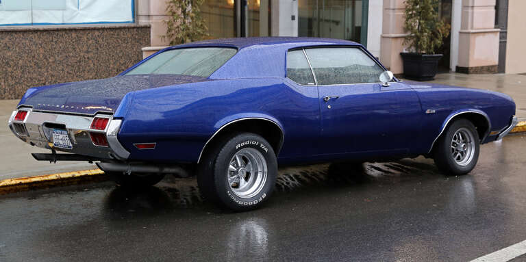 1971 Oldsmobile Cutlass Supreme &quot;Holiday Coupe&quot; (=2-door HT coupe). Built in Lansing, MI. Rather large rear wheels and some Hurst trim pieces suggest that this is a bit of a drag racer