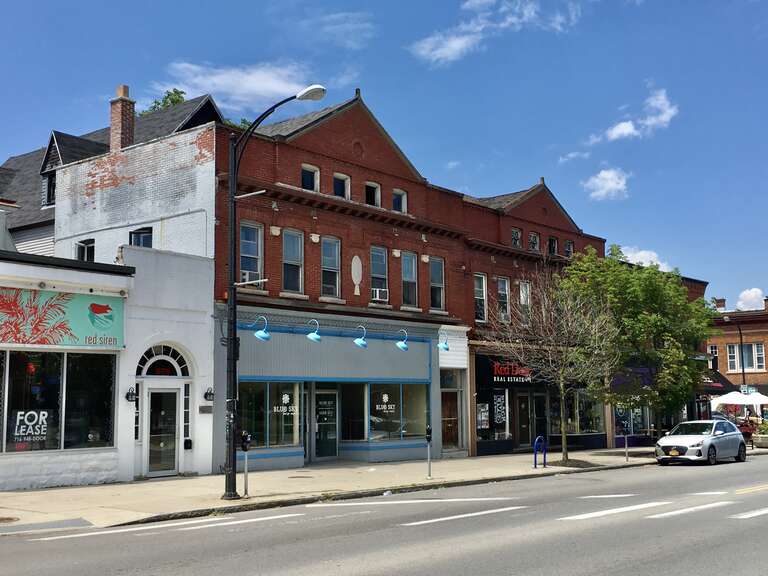 As seen in June 2020: the buildings at 976-982 Elmwood Avenue, on the west side of the block between Bidwell Parkway and Potomac Avenue, are a good example of a development phenomenon that's common in Buffalo's Elmwood Village: erstwhile detached