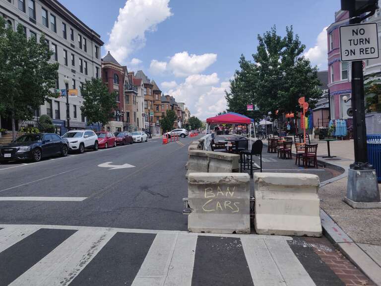 Barricades create a pedestrian zone on 18th Street Northwest in the Adams Morgan neighborhood of Washington, D.C., to give extra space to restaurants for outdoor seating during the COVID-19 pandemic. Graffiti reading &quot;ban cars&quot; adorns one block.